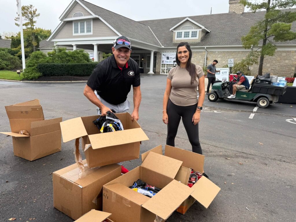 Volunteers unpacking player gifts outside the Jefferson Country Club clubhouse
